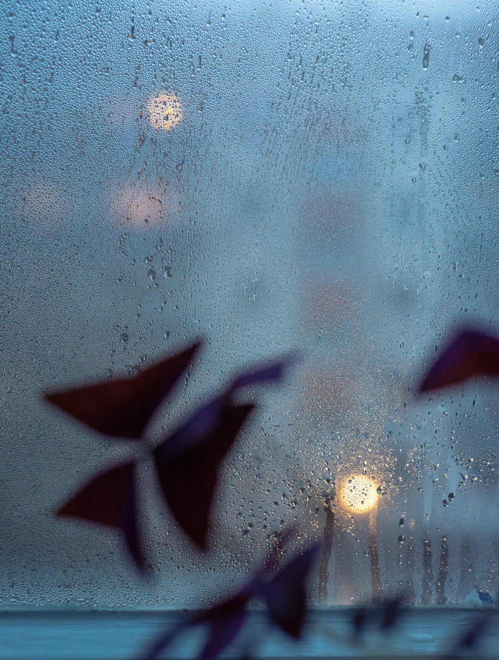 a view of a street through a rain covered window