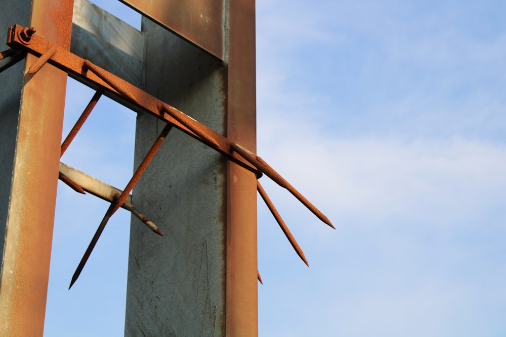 a rusted metal structure with a blue sky in the background