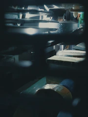 Industrial machinery in a modern factory setting with strong lighting and metallic details