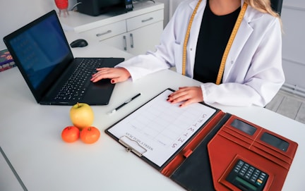 a woman sitting at a desk with a laptop