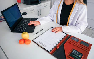 a woman sitting at a desk with a laptop
