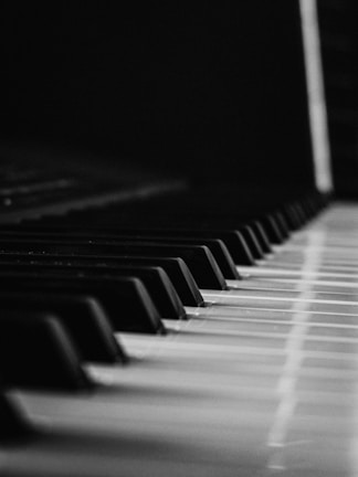 A close-up of piano keys with soft lighting highlighting the details.