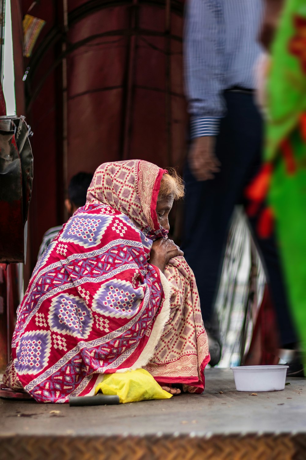 a woman sitting on the ground next to a banana