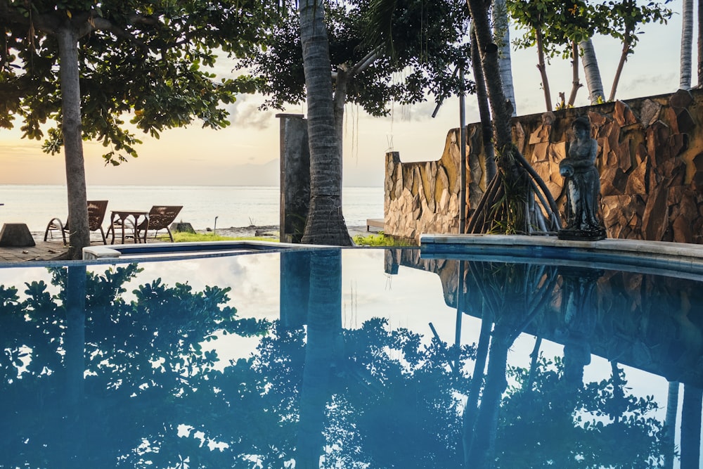 a large swimming pool with a view of the ocean