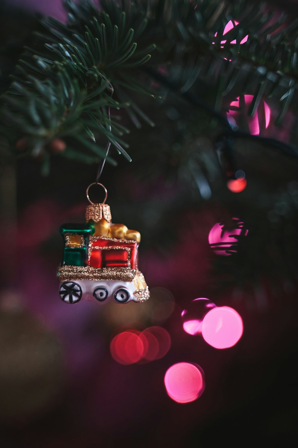 a train ornament hanging from a christmas tree