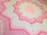 A close-up photo of a beautifully crocheted baby blanket with delicate pastel colors.
