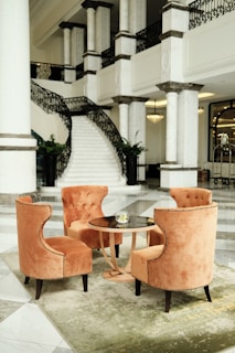 a couple of chairs sitting next to a table