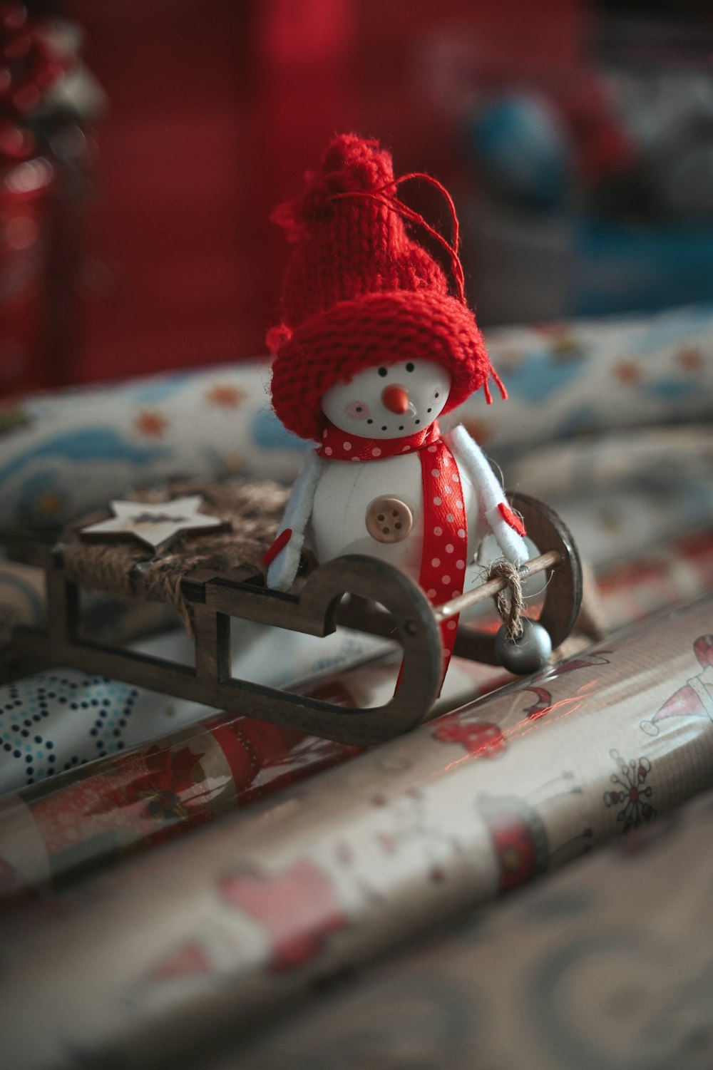 a small snowman sitting on top of a sled