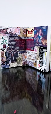 A creative and colorful journal spread filled with various cutouts, stickers, and notes. It features references to a popular TV show with images of characters, symbols, and quotes. The layout is busy, vibrant, and visually engaging, combining elements of collage art and scrapbook design.