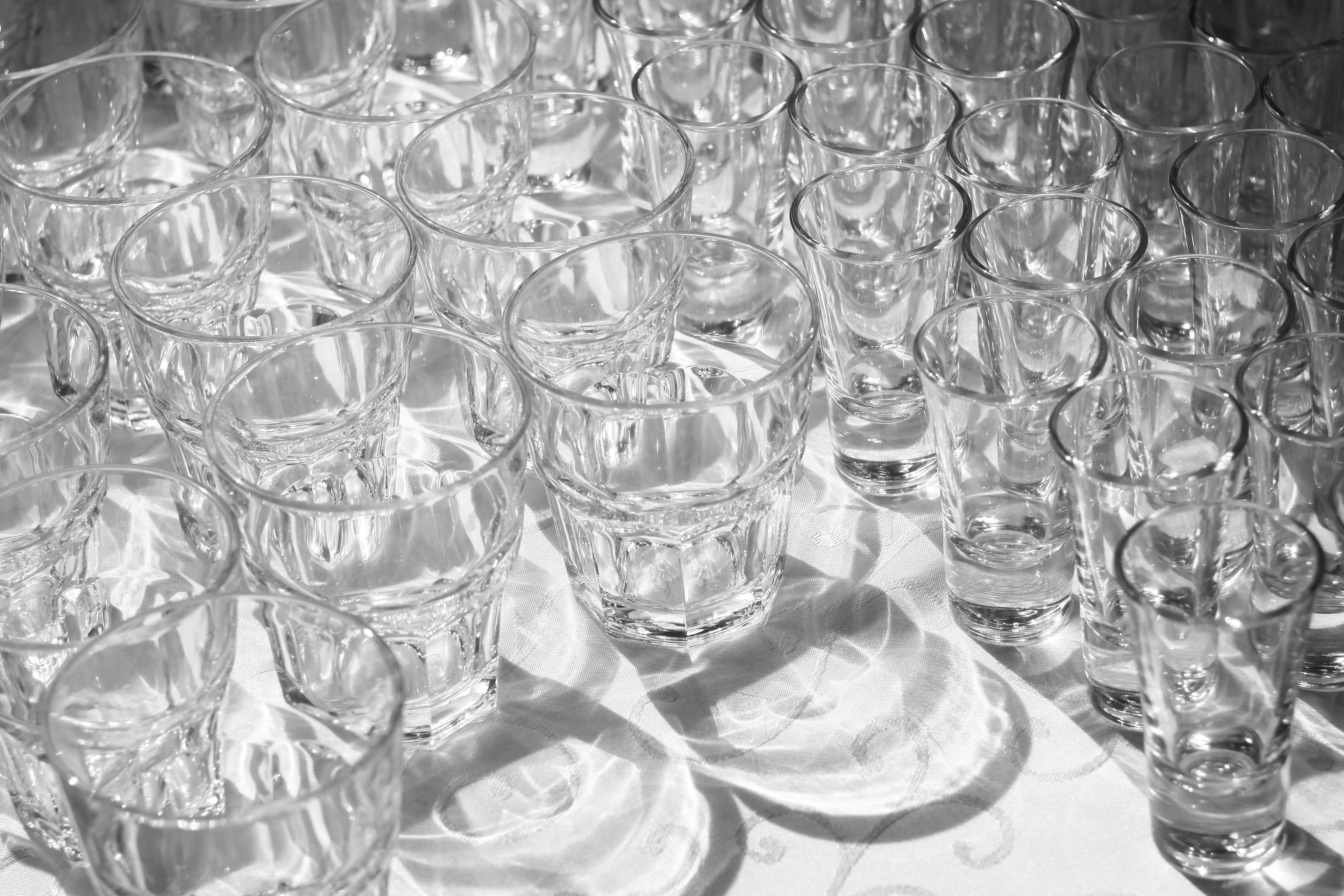 A table topped with lots of glasses filled with water photo Free