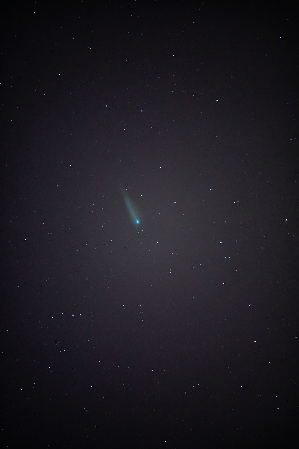 a bright green object in the middle of a night sky