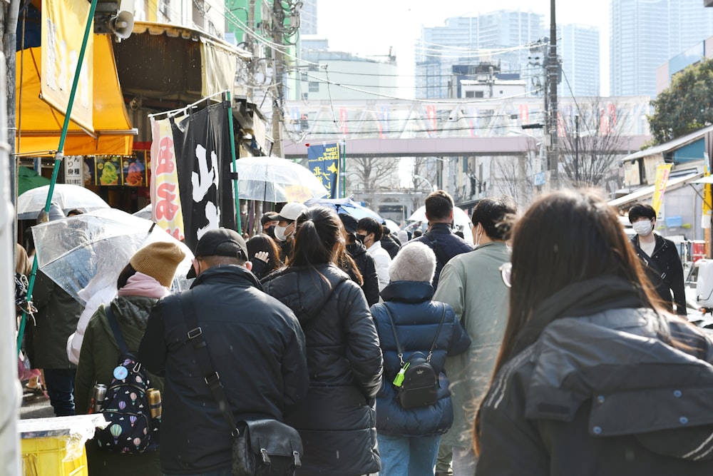 a crowd of people walking down a street