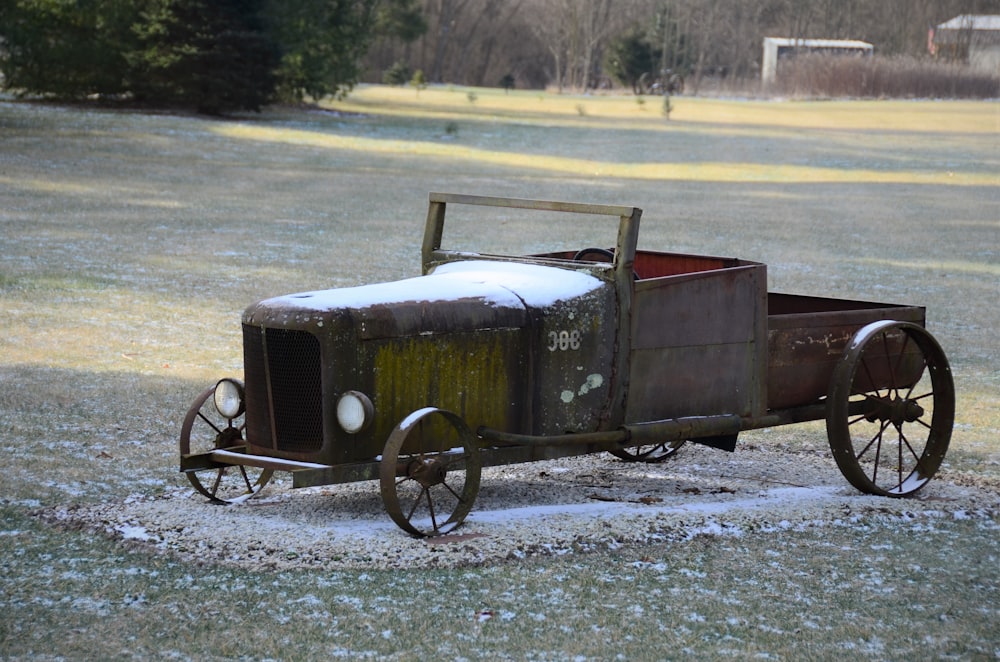 a rusted out wagon sitting in the middle of a field