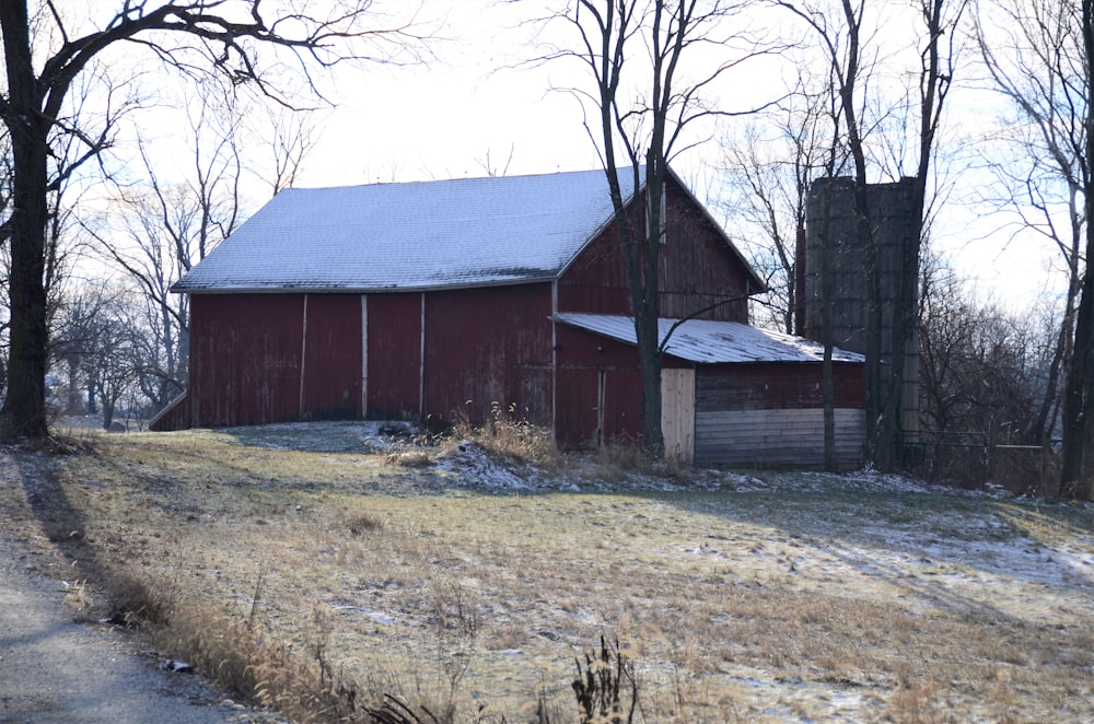 a red barn with a snow covered roof