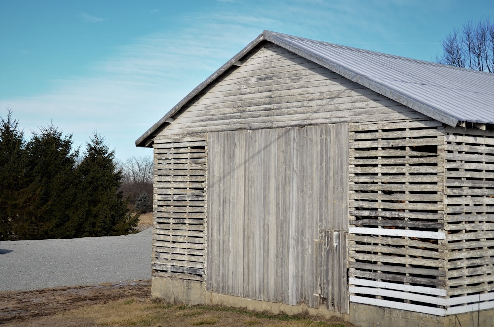 a small wooden building with a metal roof