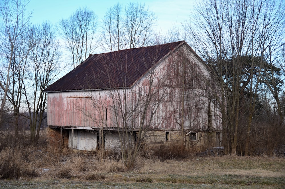 an old barn with a rusted tin roof