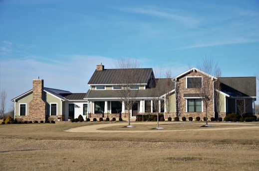 a big house with a lot of windows and a lot of grass