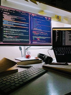 Snapshot of a workstation showcasing coding and design on multiple monitors