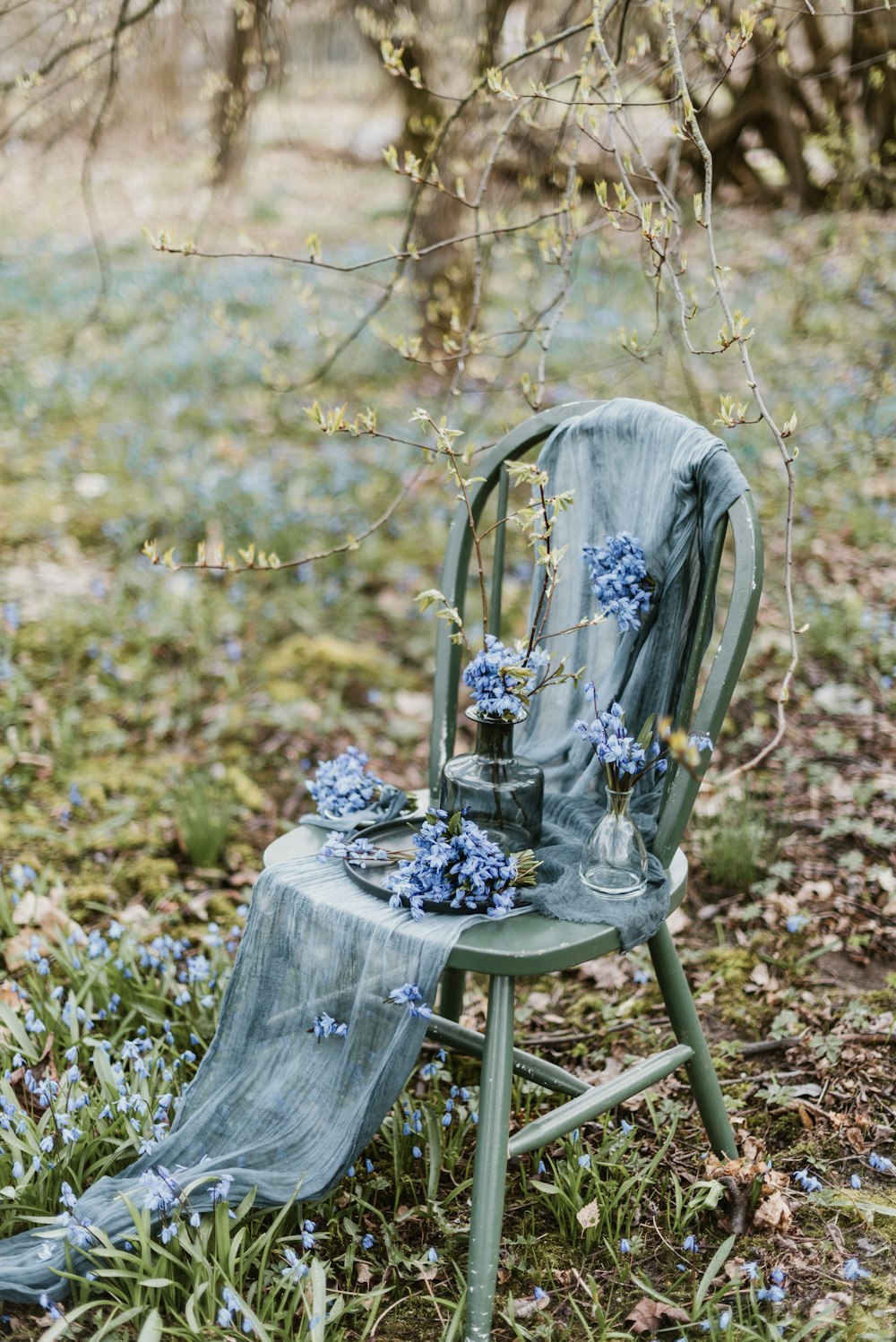 a blue chair sitting in the middle of a field