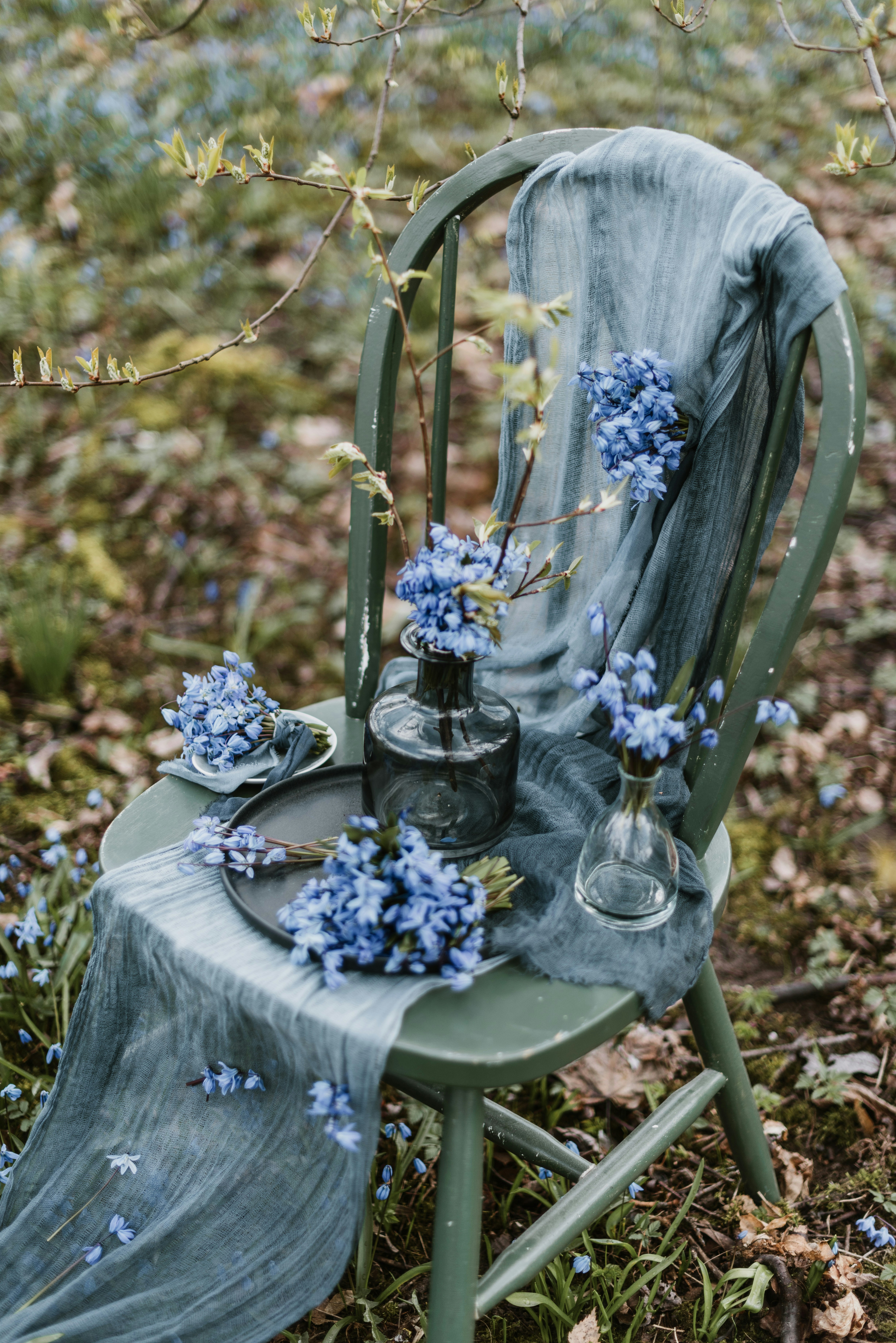 a chair with a table and vases on it