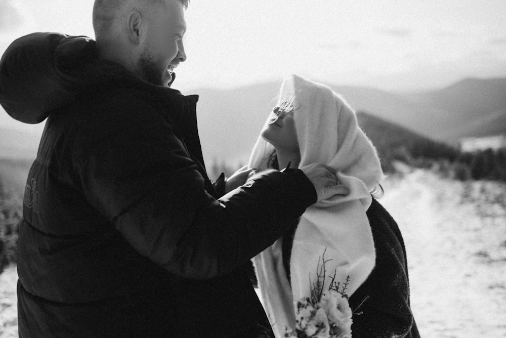 a man and a woman standing in the snow