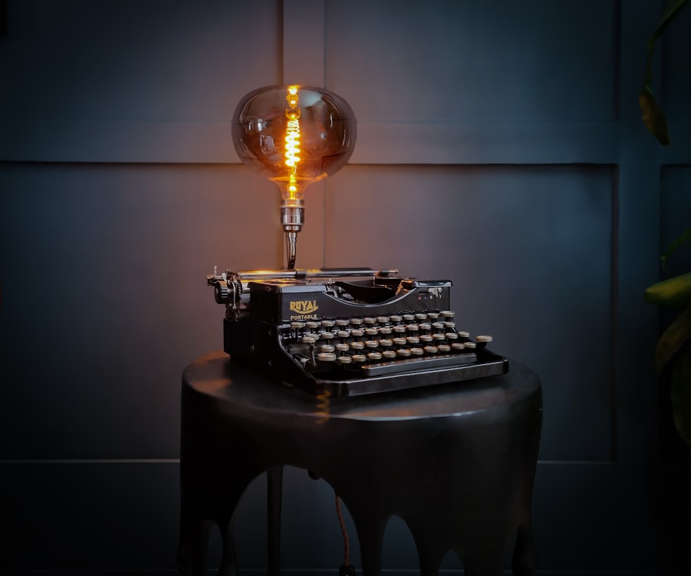 an old fashioned typewriter sitting on top of a table