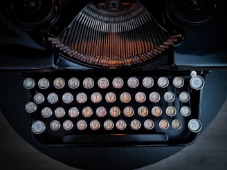 An elegant vintage typewriter with round keys on a wooden desk.