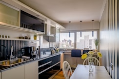a kitchen with a table and chairs next to a window