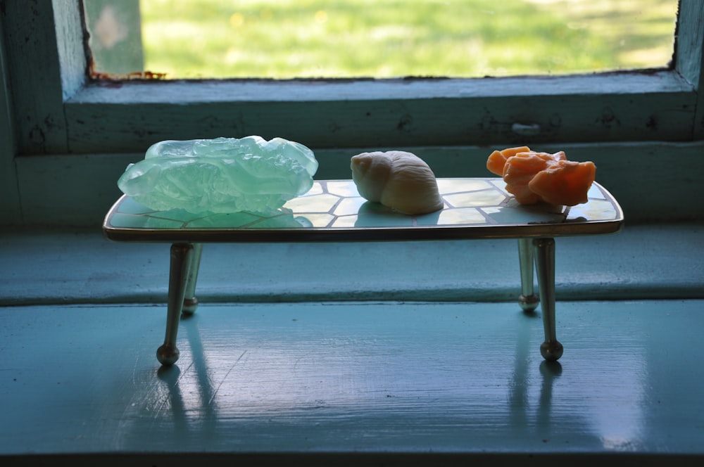 a small table with two pieces of fruit on it