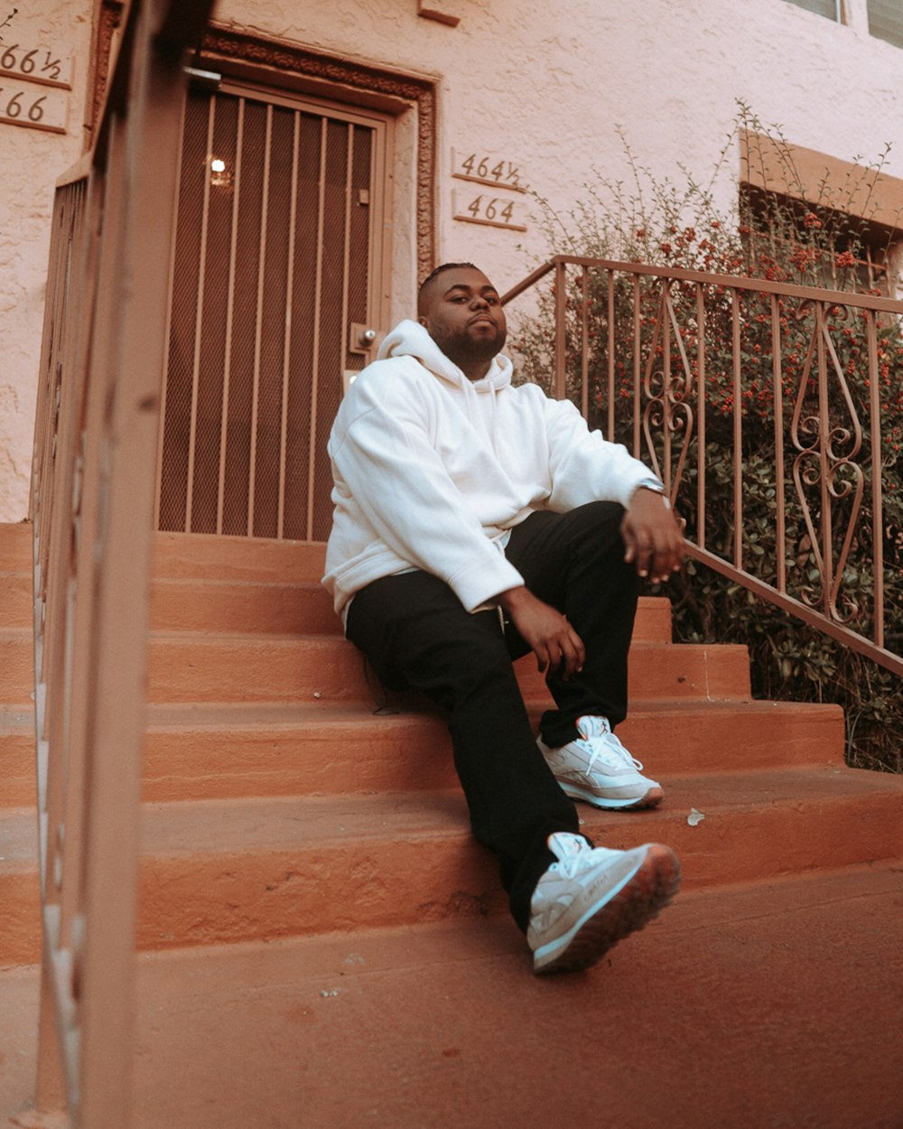 a man sitting on the steps of a building