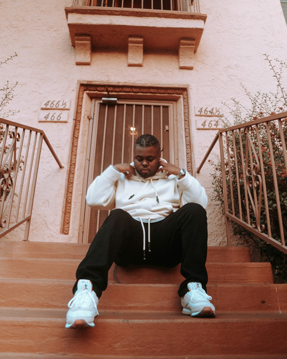 a man sitting on the steps of a building