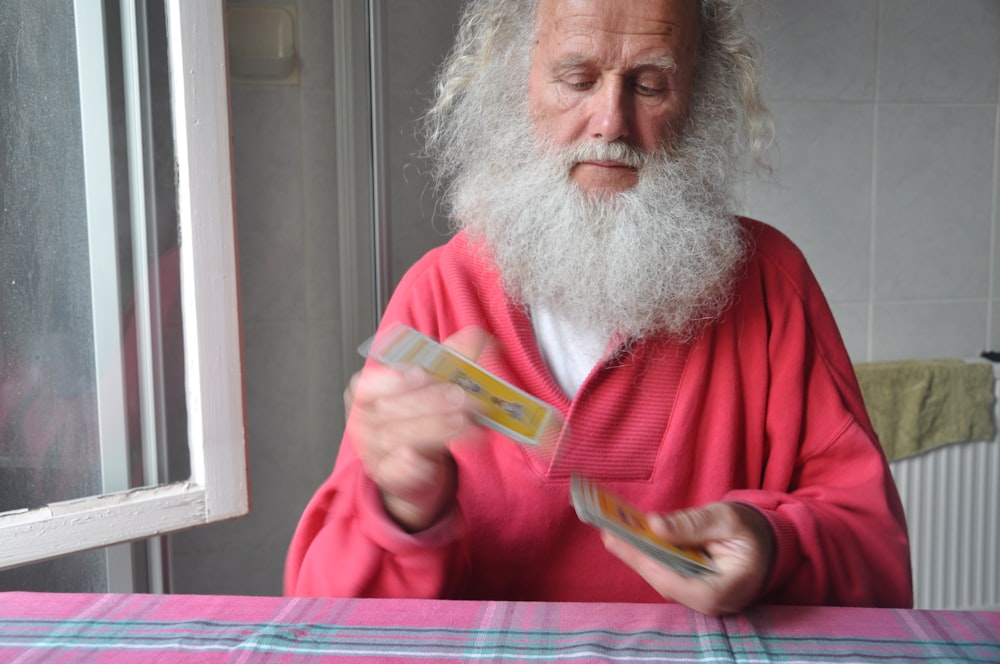 a man with a long white beard and a red robe