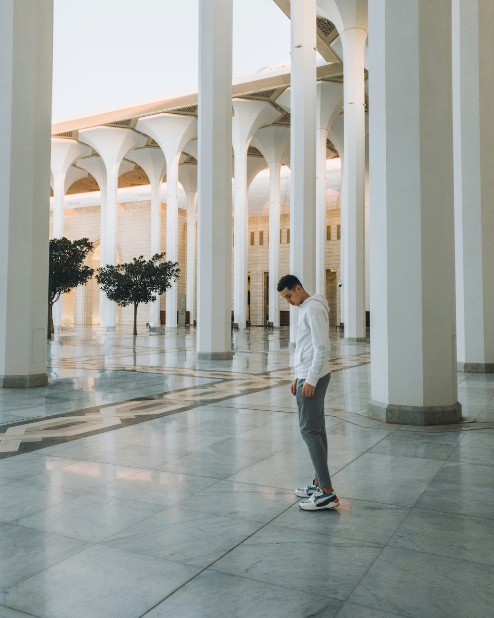 a man standing on a skateboard in a building