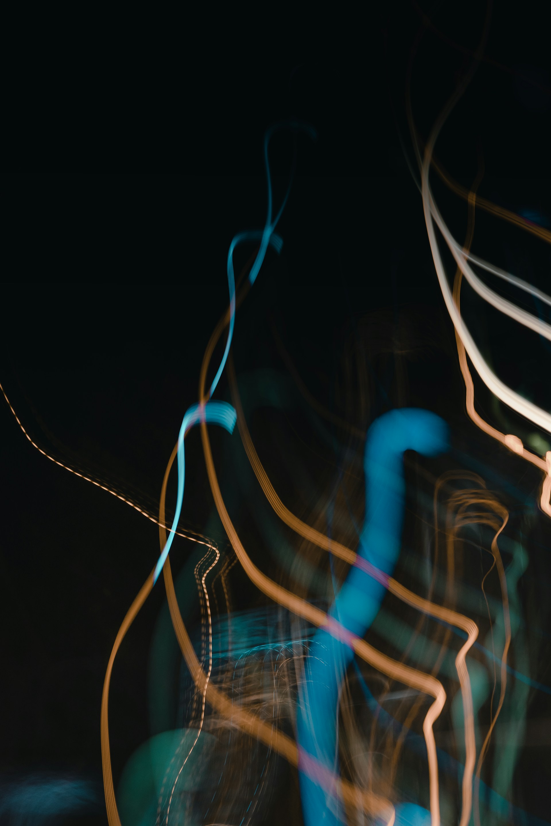 Abstract light trails illustrating speed and acceleration in processes.