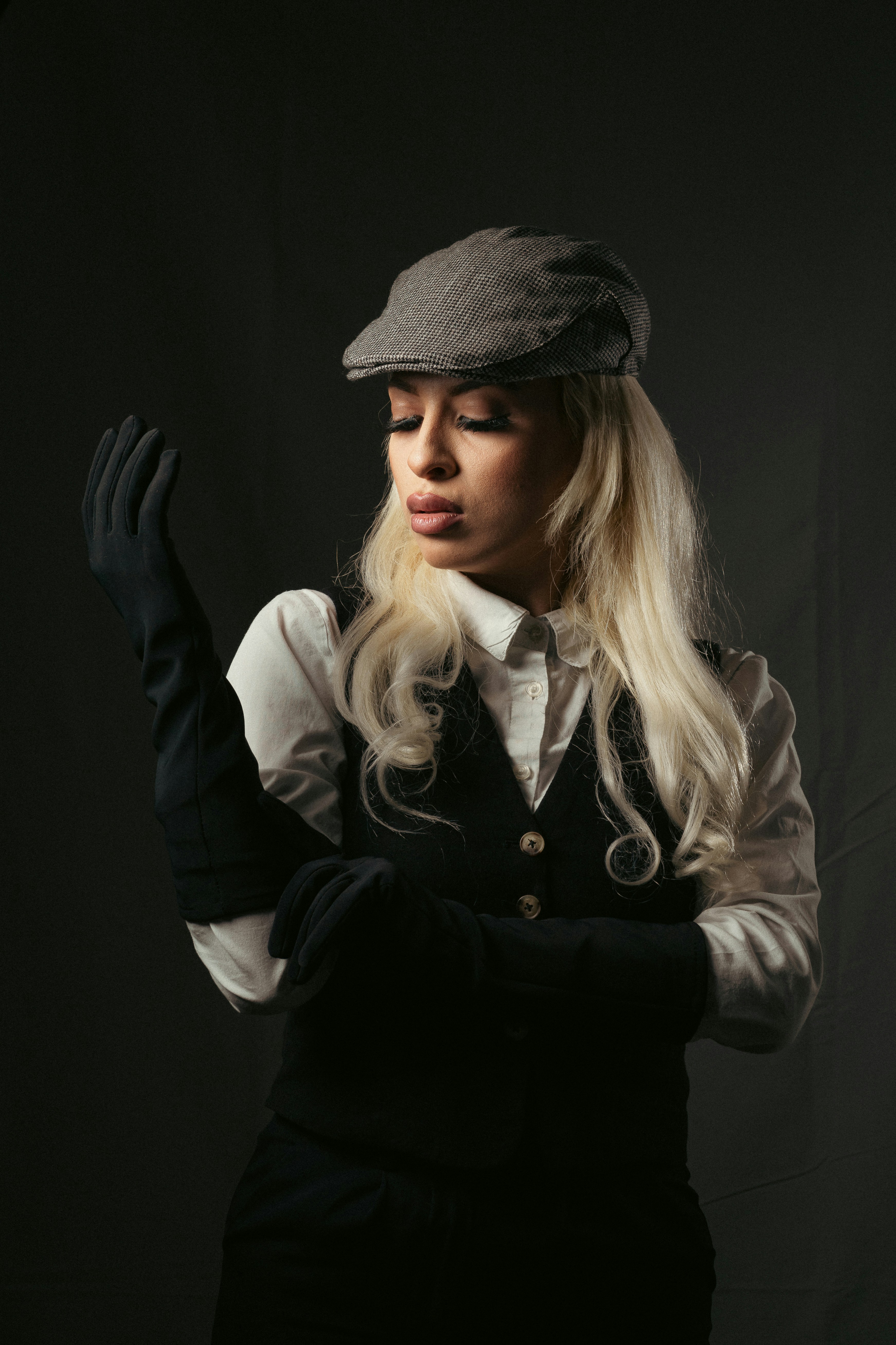 a woman with long blonde hair wearing a hat