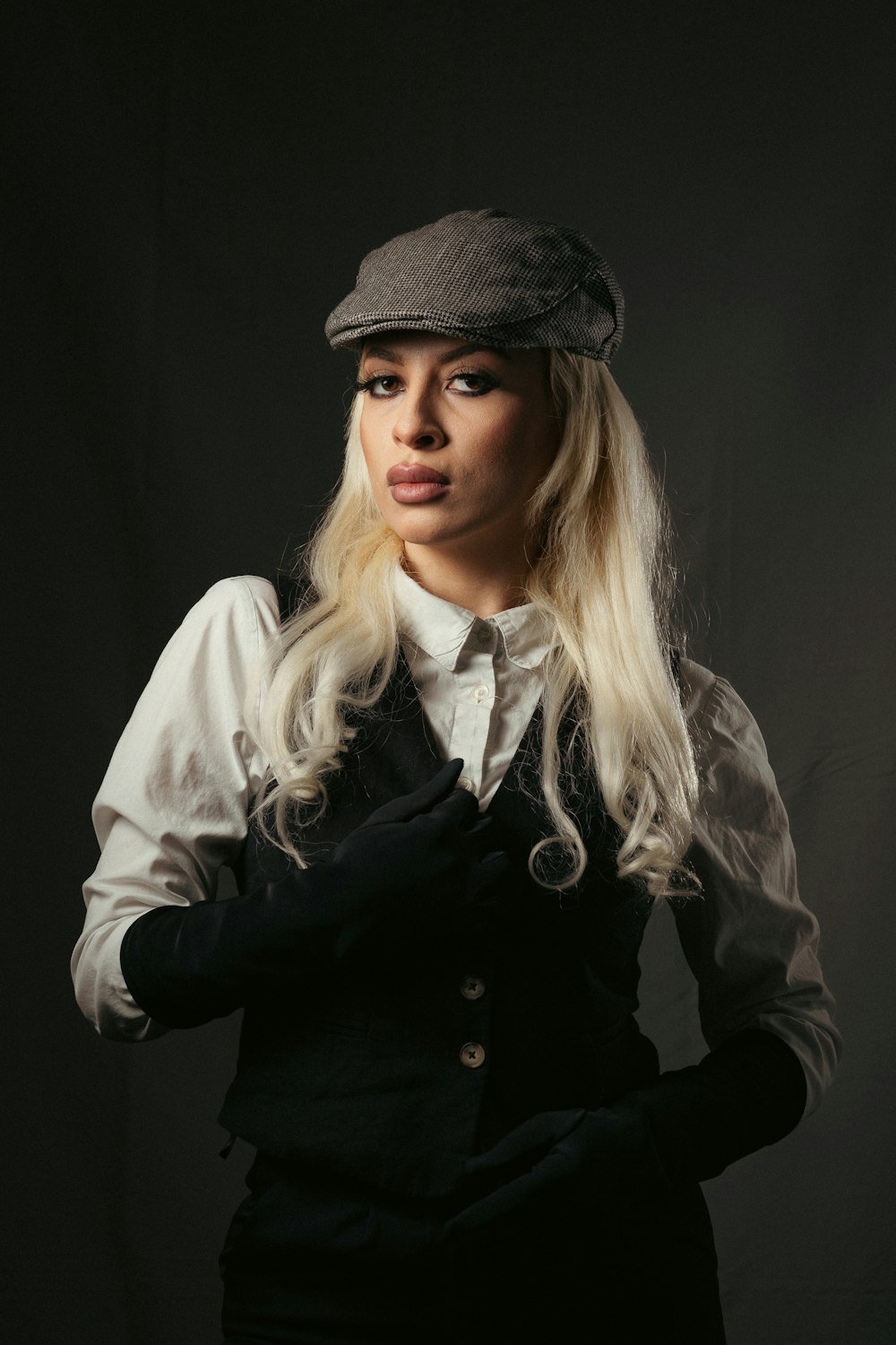 a woman with long blonde hair wearing a hat