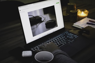 a person sitting in front of a laptop computer