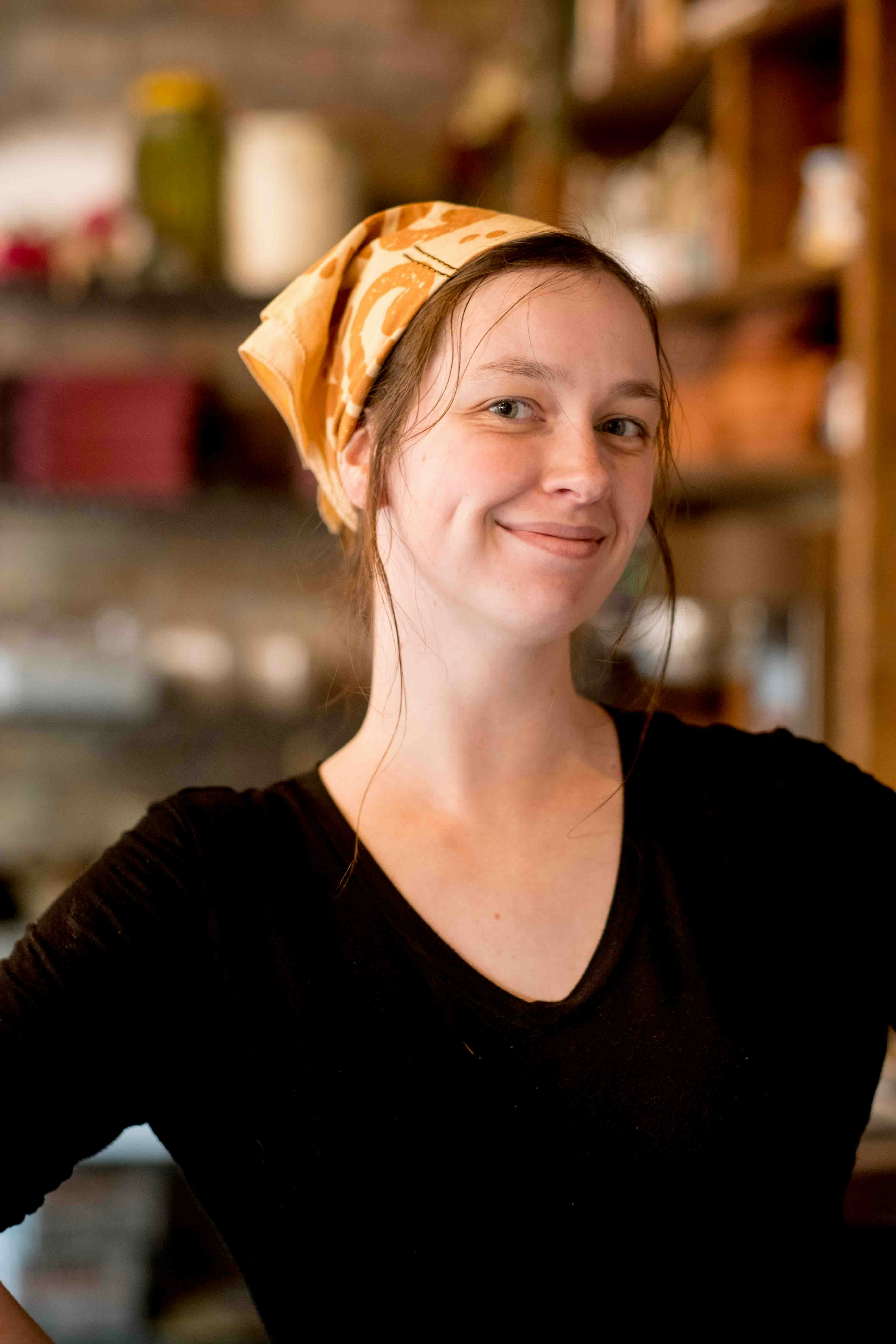 a woman with a yellow bandana on her head