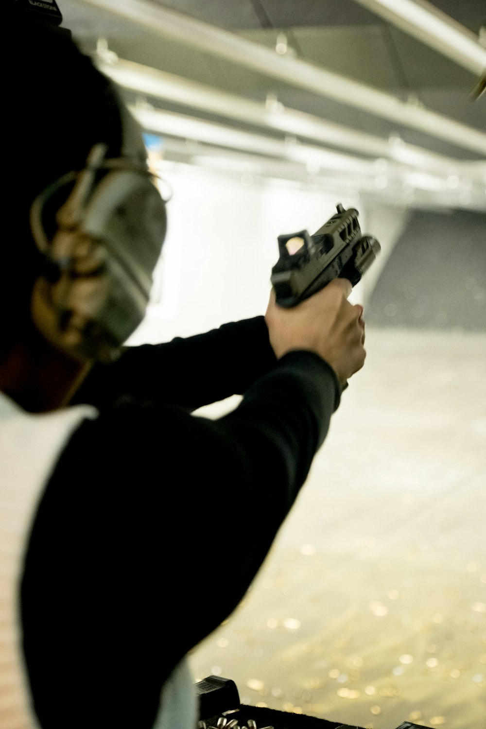 a man holding a gun in his right hand