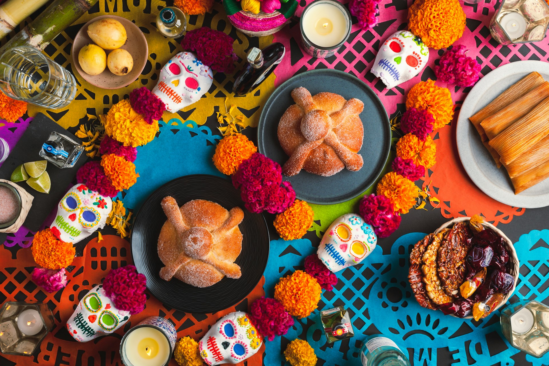 a table topped with plates of food and candles