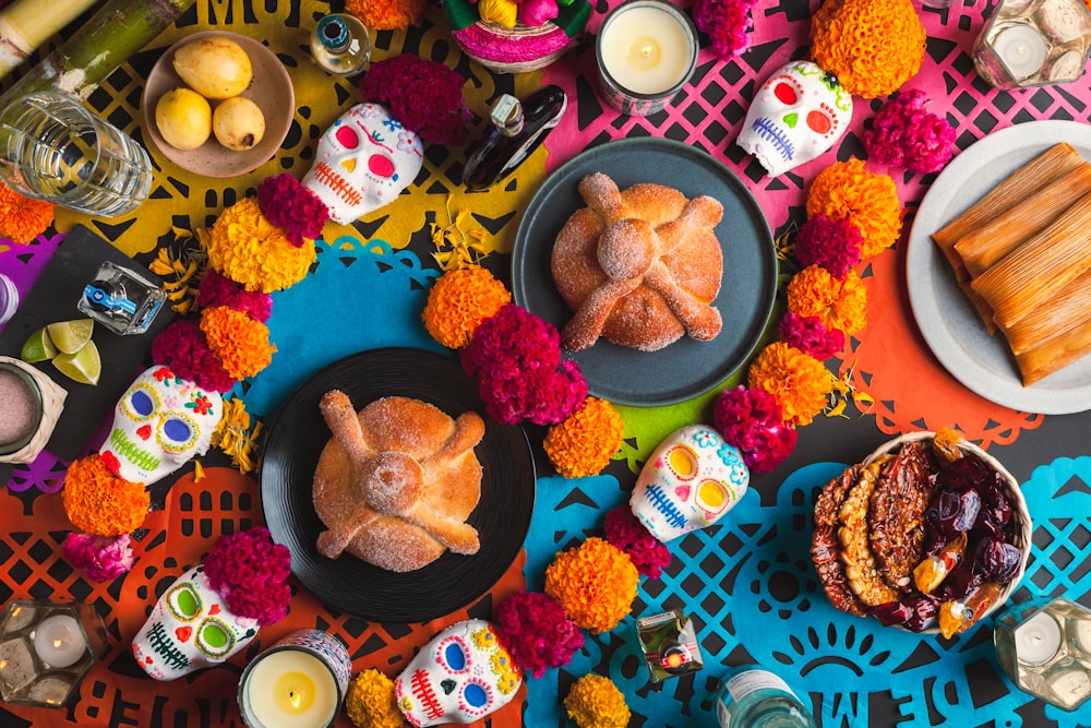 a table topped with plates of food and candles