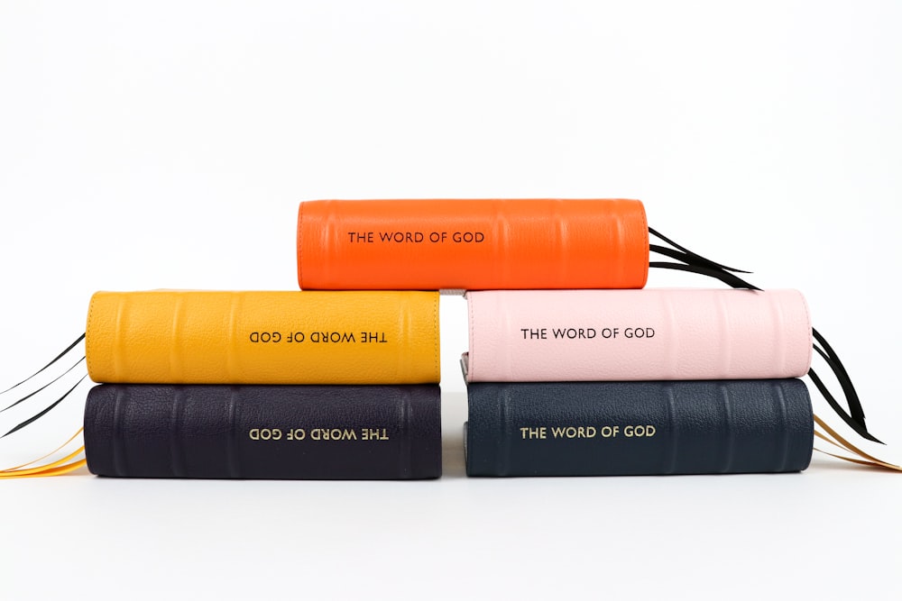 a stack of four books with the words the word of god written on them