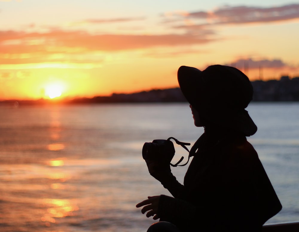 a person sitting on a bench looking at the water