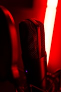 A close-up of a microphone on a stage with soft lighting.