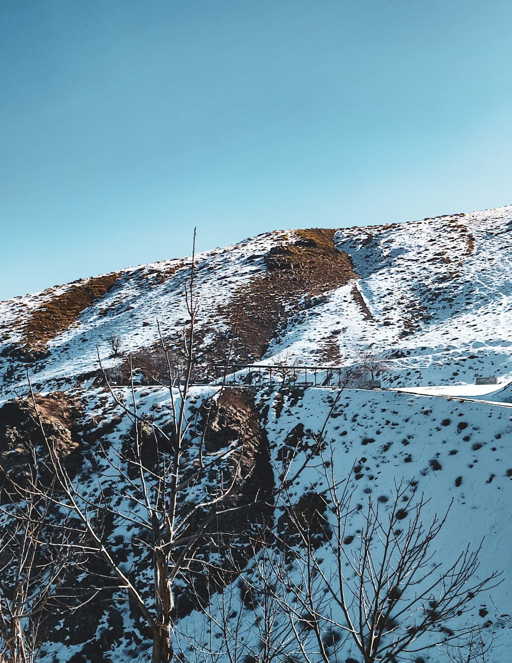 a man riding a snowboard down a snow covered slope