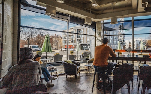 a group of people sitting at a table in a restaurant