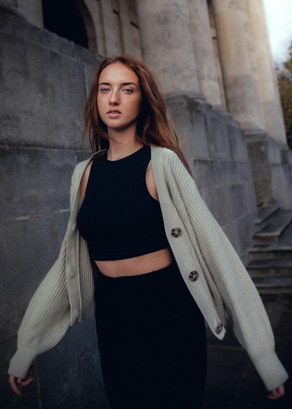 a woman standing in front of a building