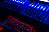 Sound board with glowing controls in a dimly lit worship setting.