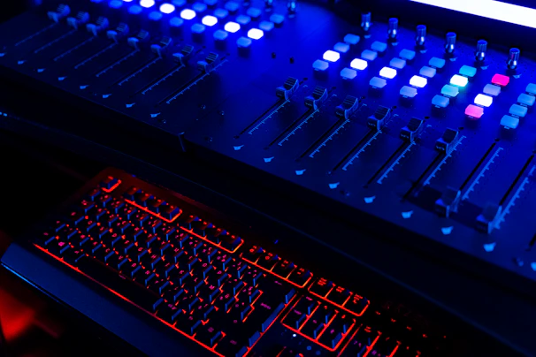 Close-up of a soundboard with glowing orange and purple neon buttons.