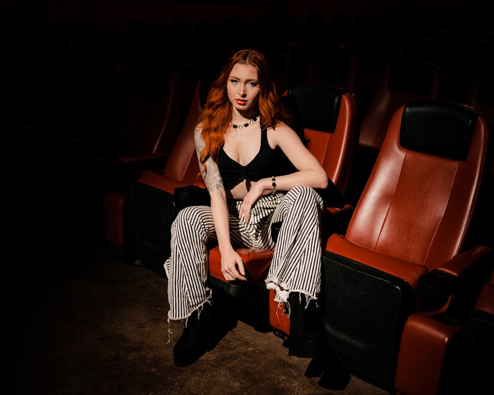 a woman with red hair sitting in a theater